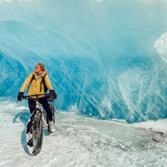 Woman Riding a Bike Through Glaciers